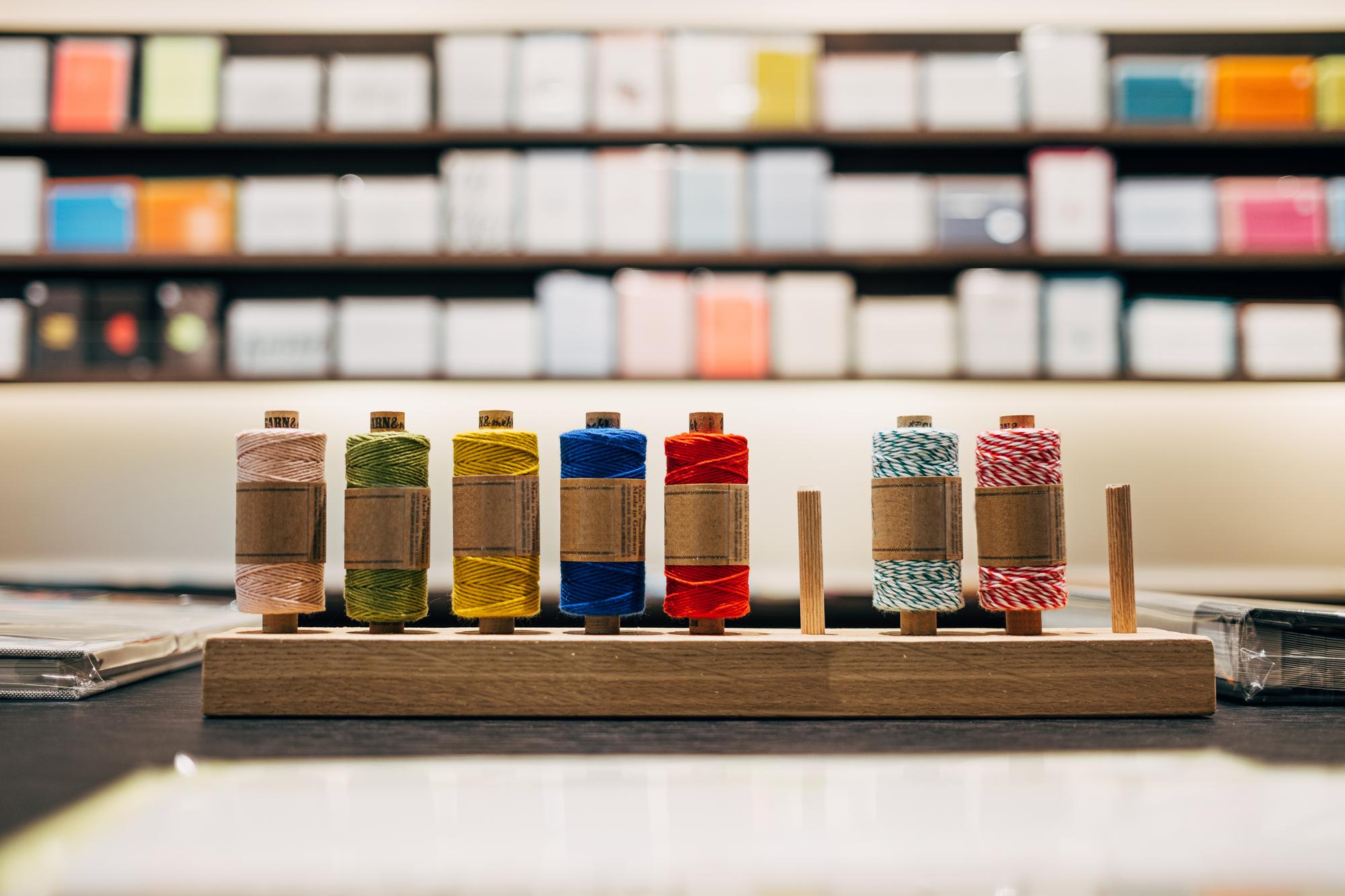atelier workspace with embroidery machine and thread spools