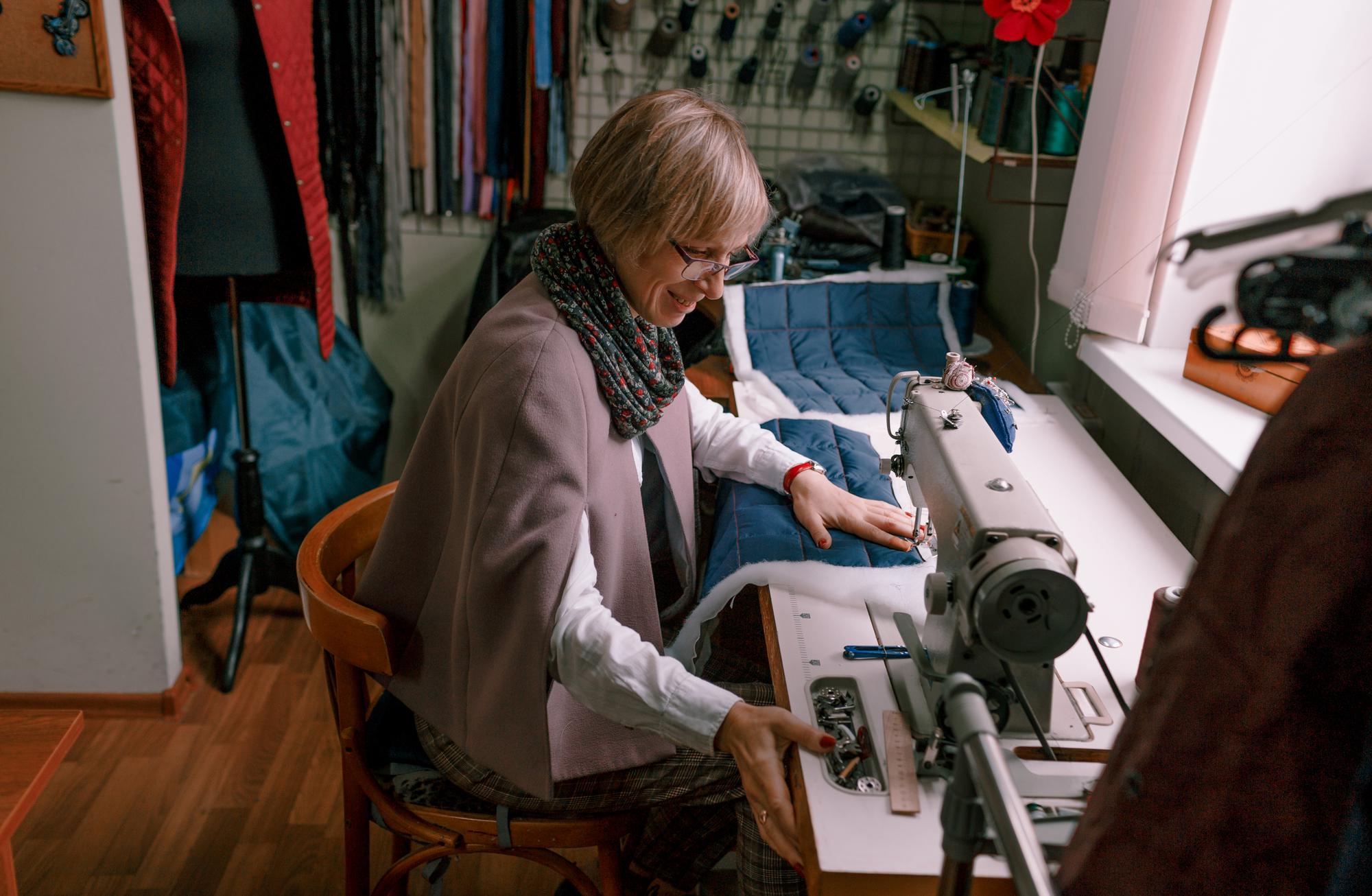 embroiderer at machine adjusting design